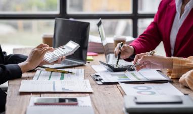 group-of-confident-business-people-point-to-graphs