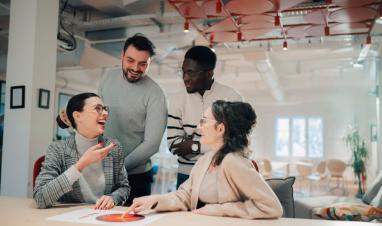 marketing-team-analyzing-charts-and-laughing-durin