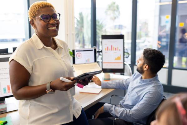 presenting-data-on-tablet-businesswoman-smiling