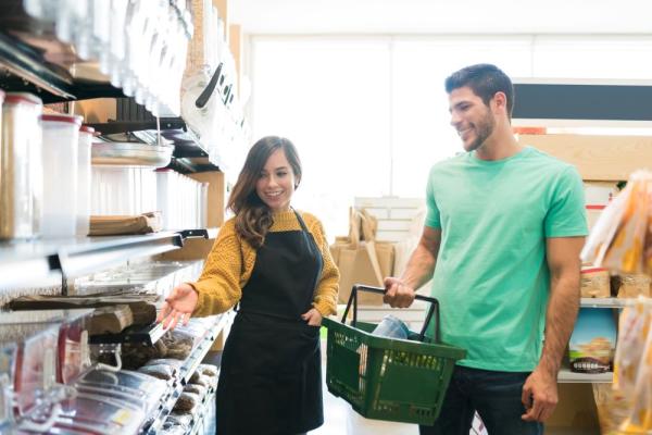 saleswoman-showing-food-products-to-consumer