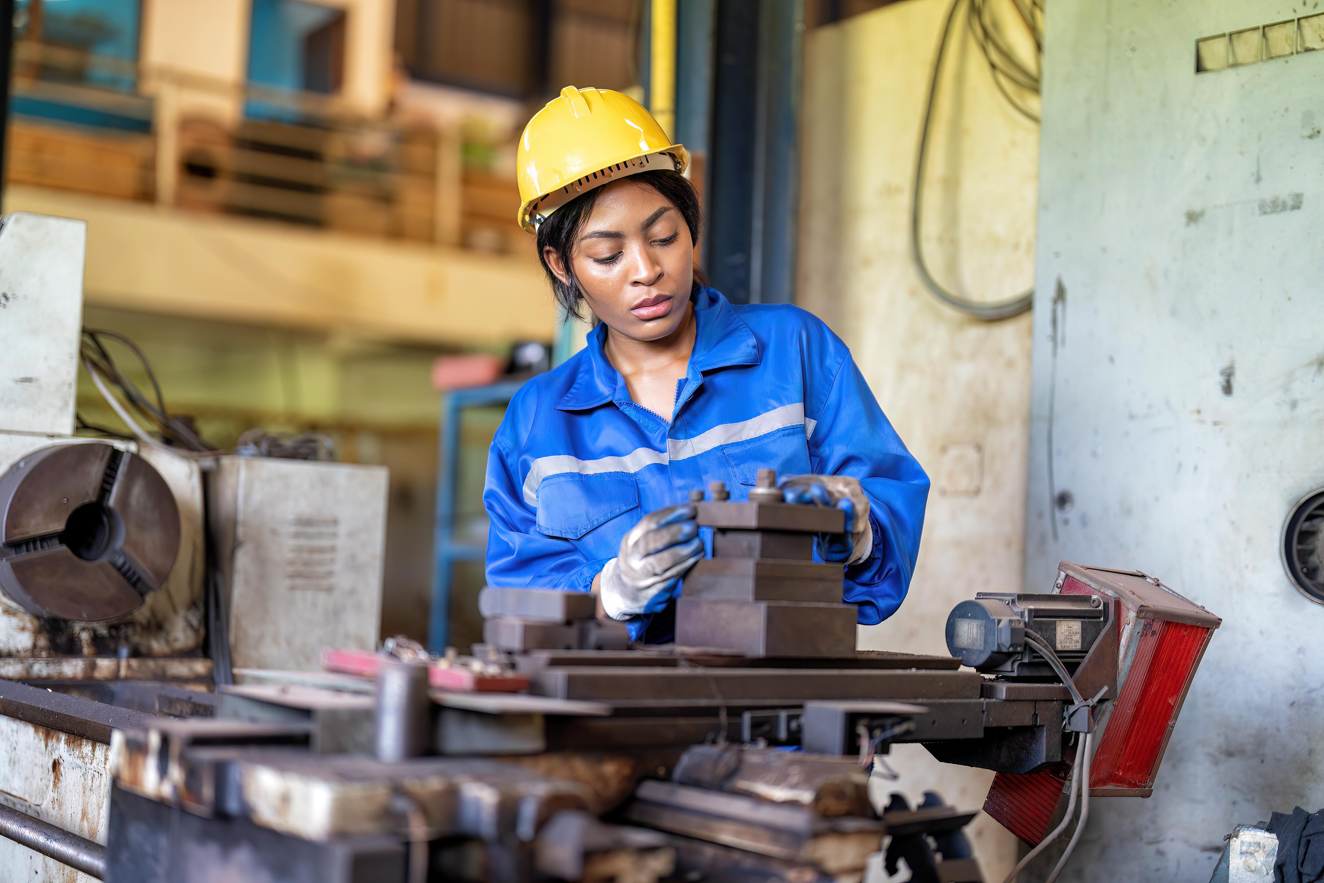 woman-worker-in-uniform-operating-machine